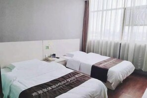 A hotel room with two beds, a nightstand, and a window with curtains. - Cinda Hotel (Zhaoyuan)