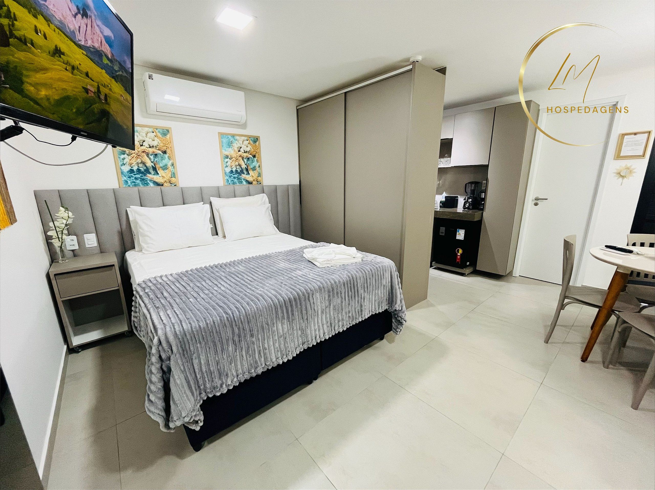 Habitació d'hotel moderna amb llit, taules de nit, escriptori i una cadira.