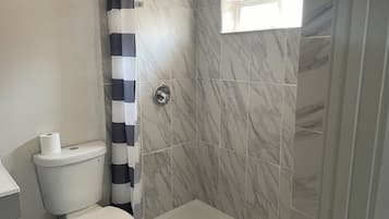 Shower, towels, soap, toilet paper