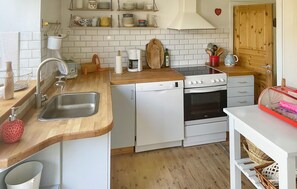 Fridge, stovetop, dishwasher, coffee/tea maker