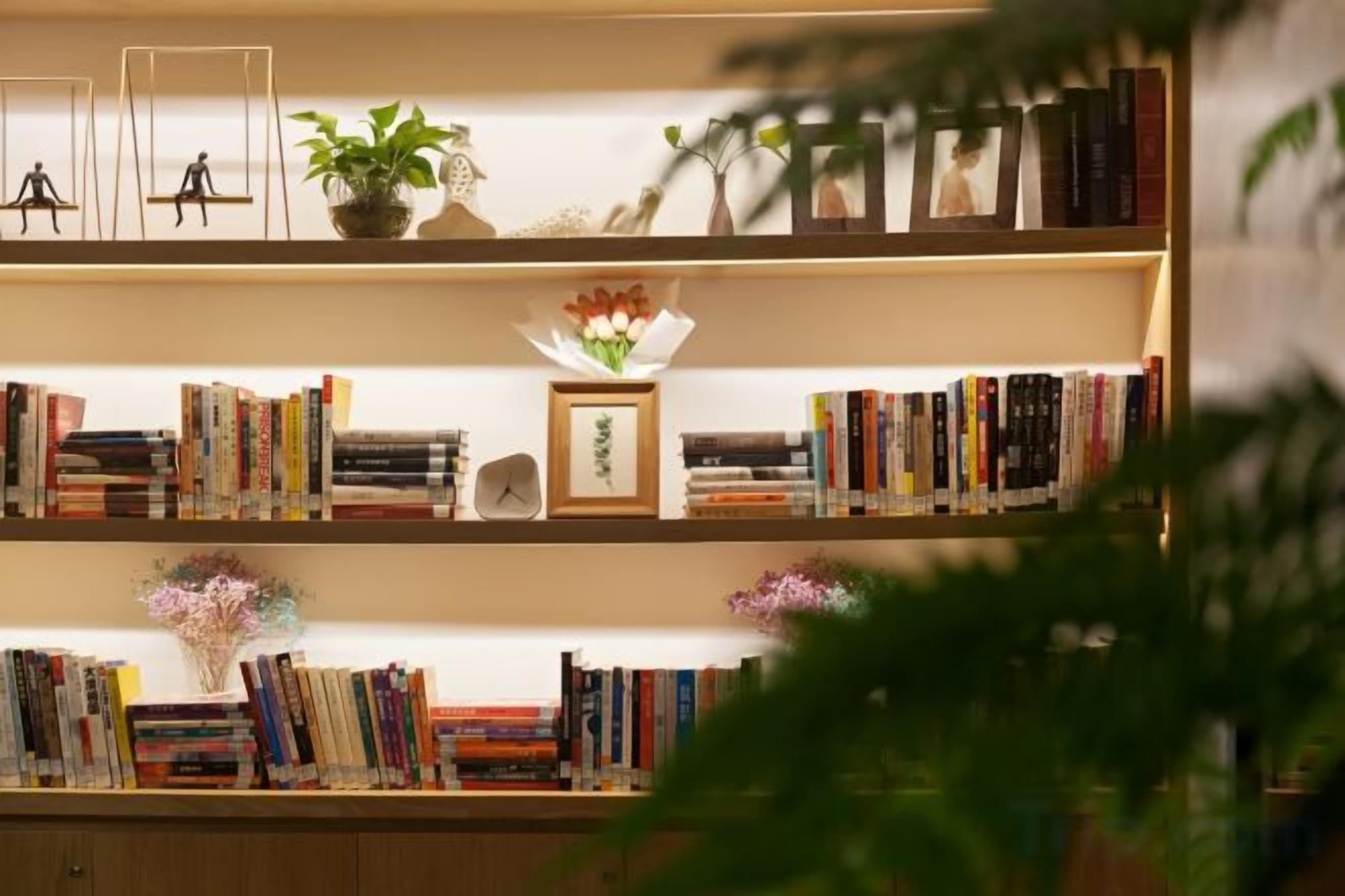 A bookshelf with books and decorative items.