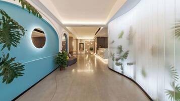 A hallway with a curved ceiling, a blue accent wall with a circular cutout, and a plant.