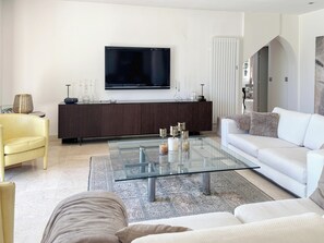 Tv, eldstad, ett bordtennisbord och böcker
