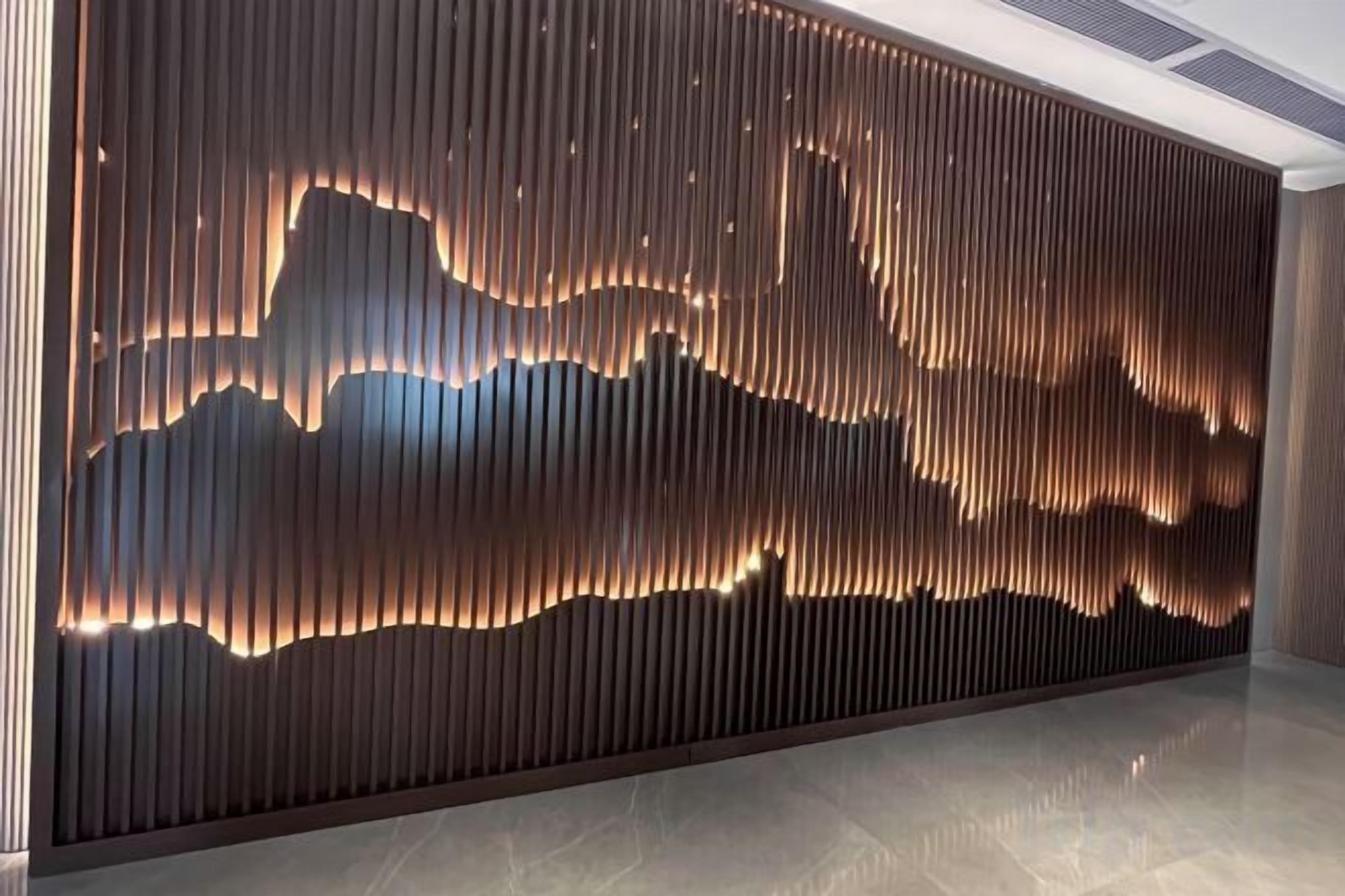 A wall with vertical slats and a lighted design.