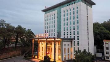 A multi-story hotel with a prominent entrance and a large sign above the doors.