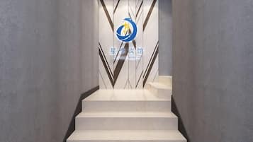 Escada que leva a um quarto com um logotipo na parede.