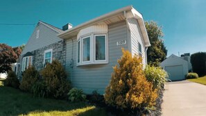 A single-story mobile home with a stone facade, a front porch, and a number '3109' on the side.
