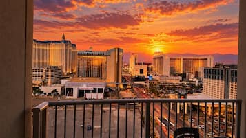 A cityscape with high-rise buildings, a casino, and a sunset.