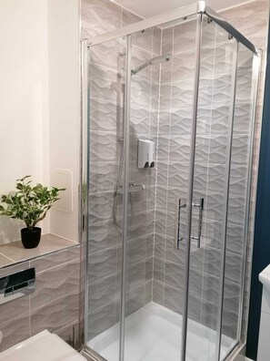 Shower, hair dryer, towels, soap