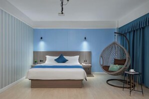 A modern bedroom with a large bed, hanging chair, bedside tables, and a ceiling light. - Xinyue Business Hotel (Dongguan)