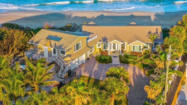 A beachfront property with a spacious patio, a covered outdoor area, and a view of the ocean. - 3435 S Highway A1A (Melbourne Beach)