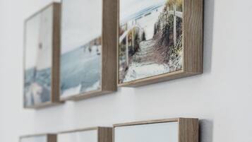A wall with four framed pictures.