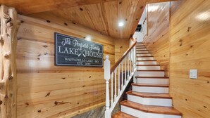 A wooden interior with a sign reading "The Penfield Family Lake House Wappapello Lake, MO, Established 2013."