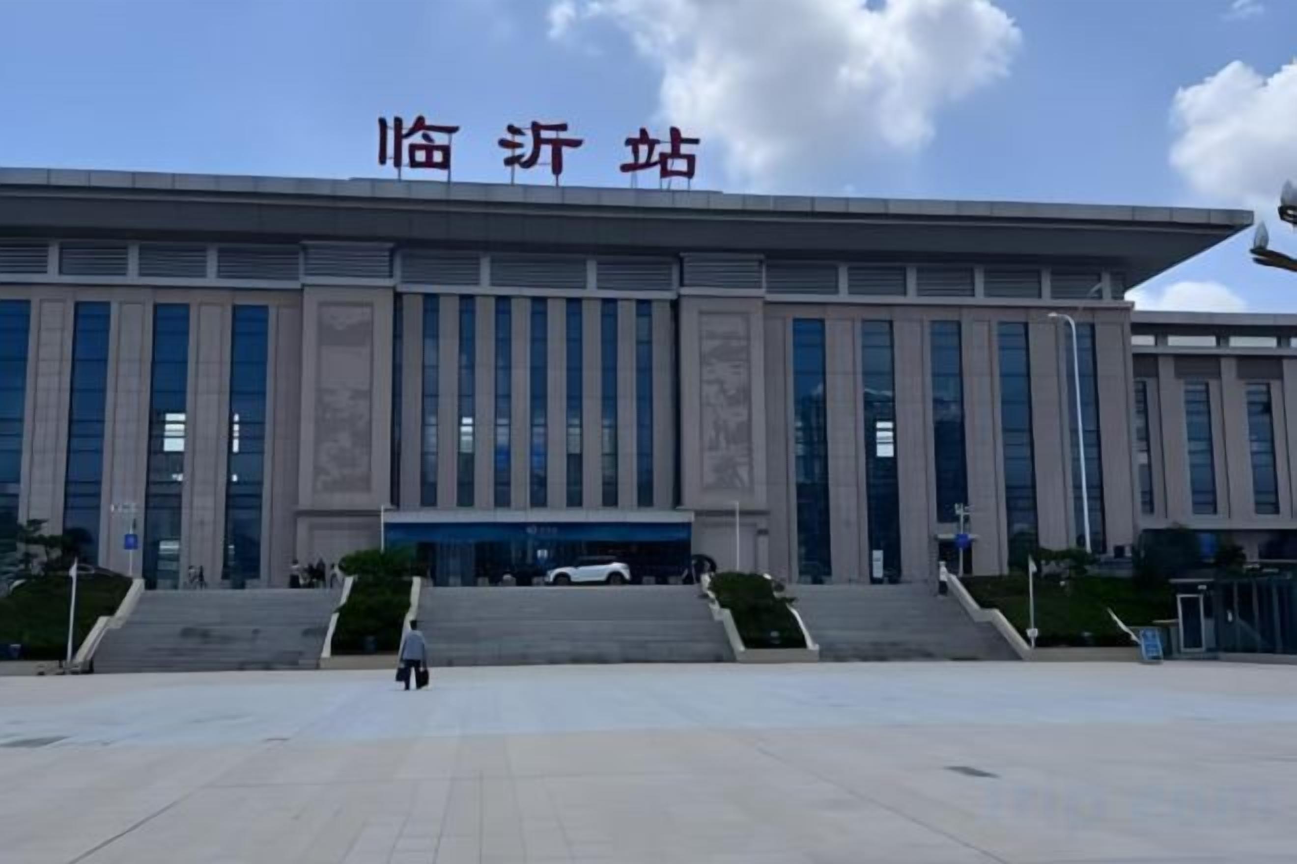 A large building with a prominent entrance and steps leading up to it.