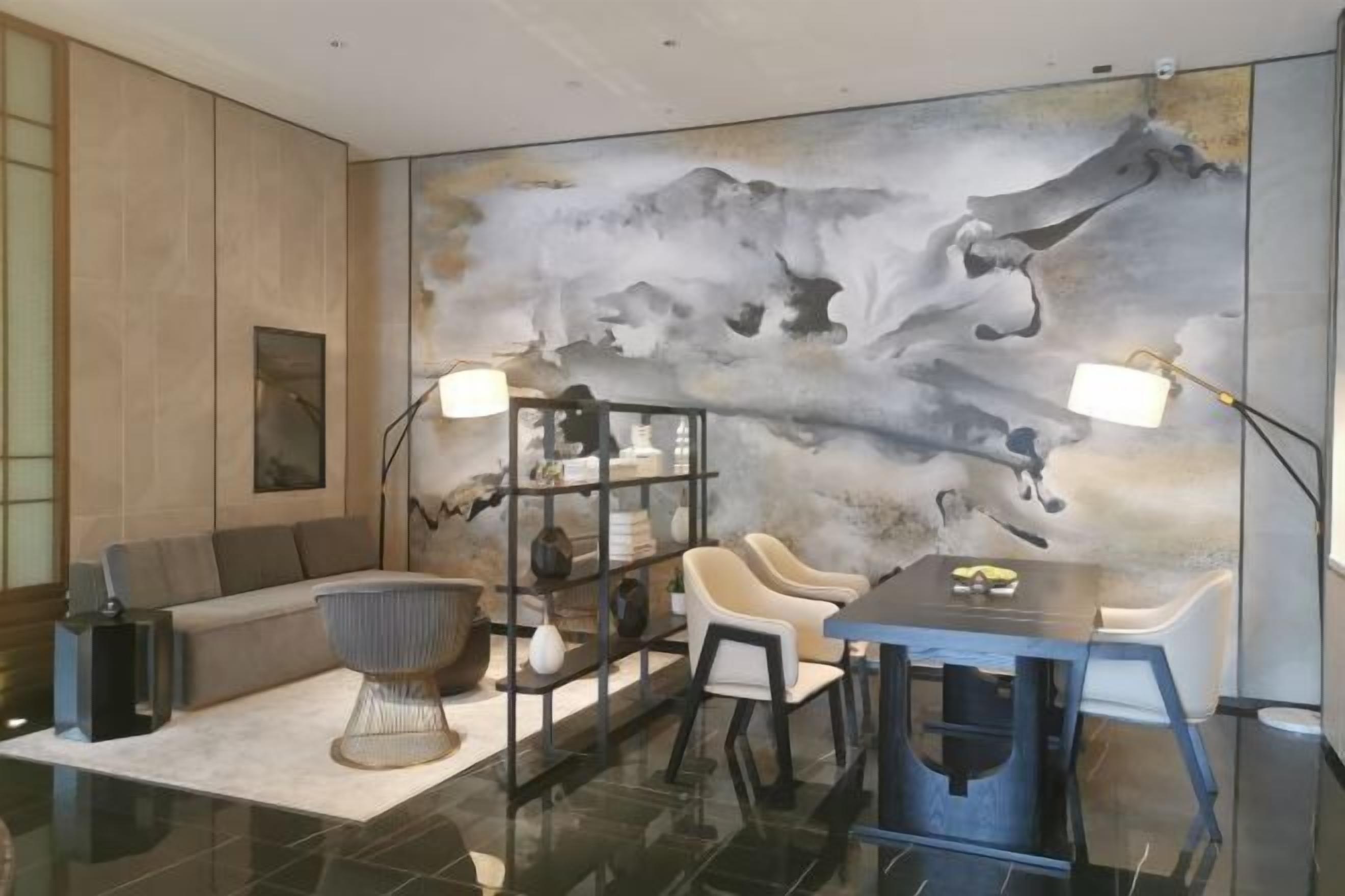A modern interior with a sofa, chairs, a dining table, and a bookshelf.