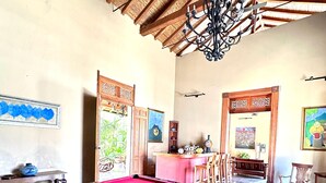 A pool table in a room with a patterned carpet, wooden furniture, and a ceiling with wooden beams. - Hotel Colonial Victonella (Granada)