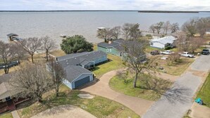A residential area with houses, a dock, and a lake. - Lakefront Family Retreat– Private Dock & Fire Pit​ (Kemp)