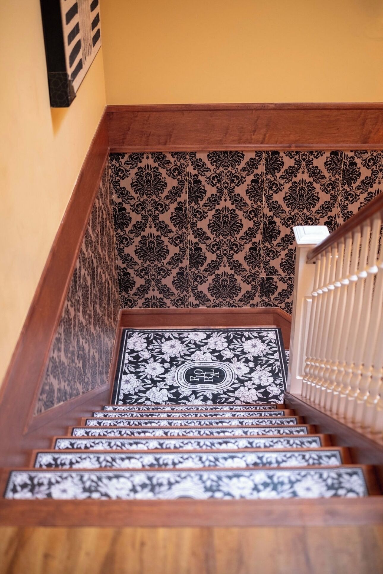A staircase with patterned carpet and wooden steps.