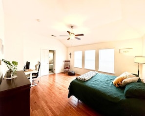 Cozy retreat with a bed, desk, and chair, perfect for relaxation and work.