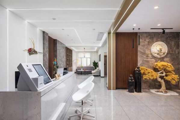 A reception area with a counter, seating, and decorative elements.