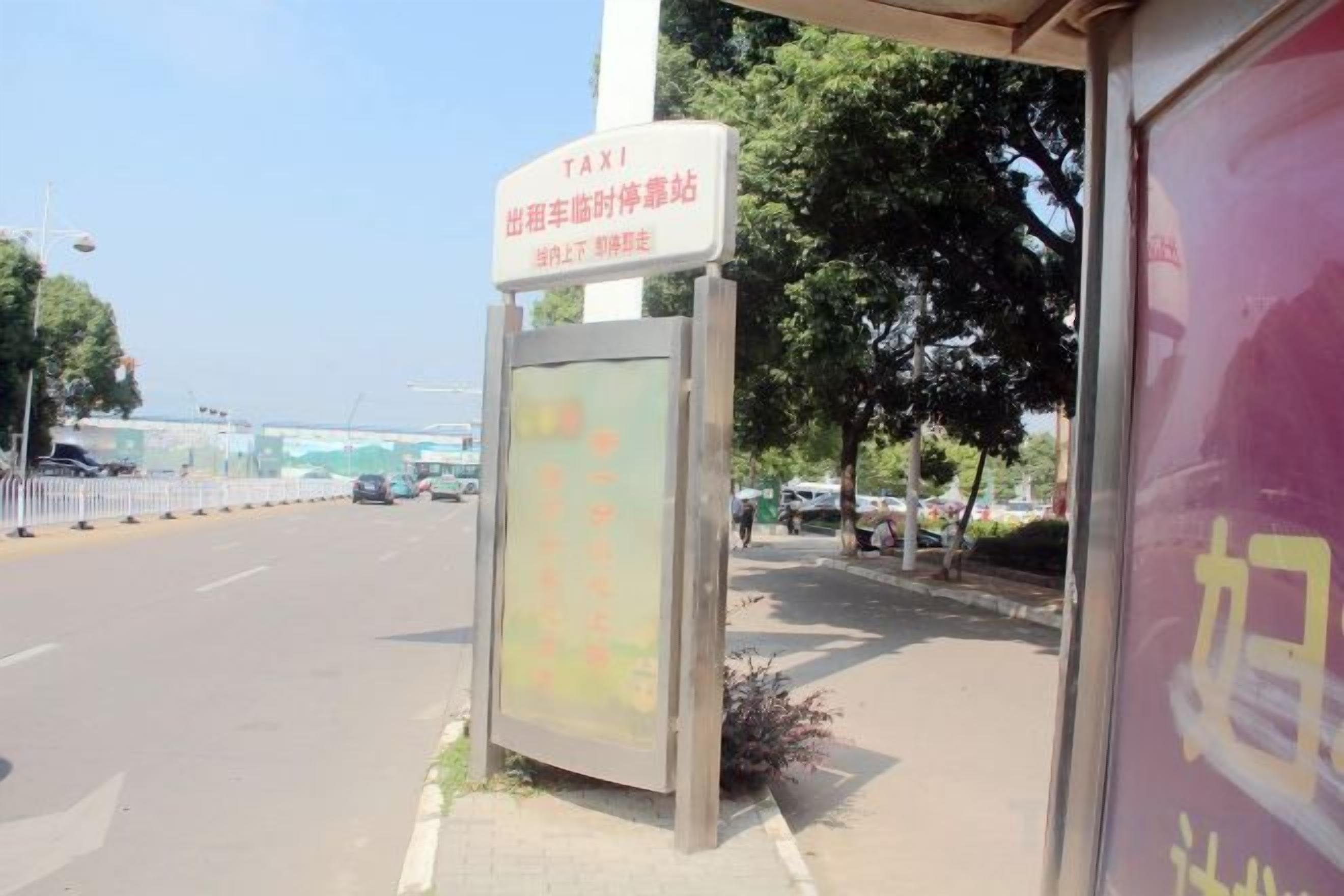 A taxi stand with a sign indicating it's for taxis.