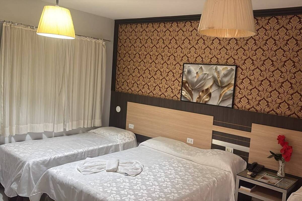Deluxe Quadruple Room | Minibar, desk, laptop workspace, blackout curtains