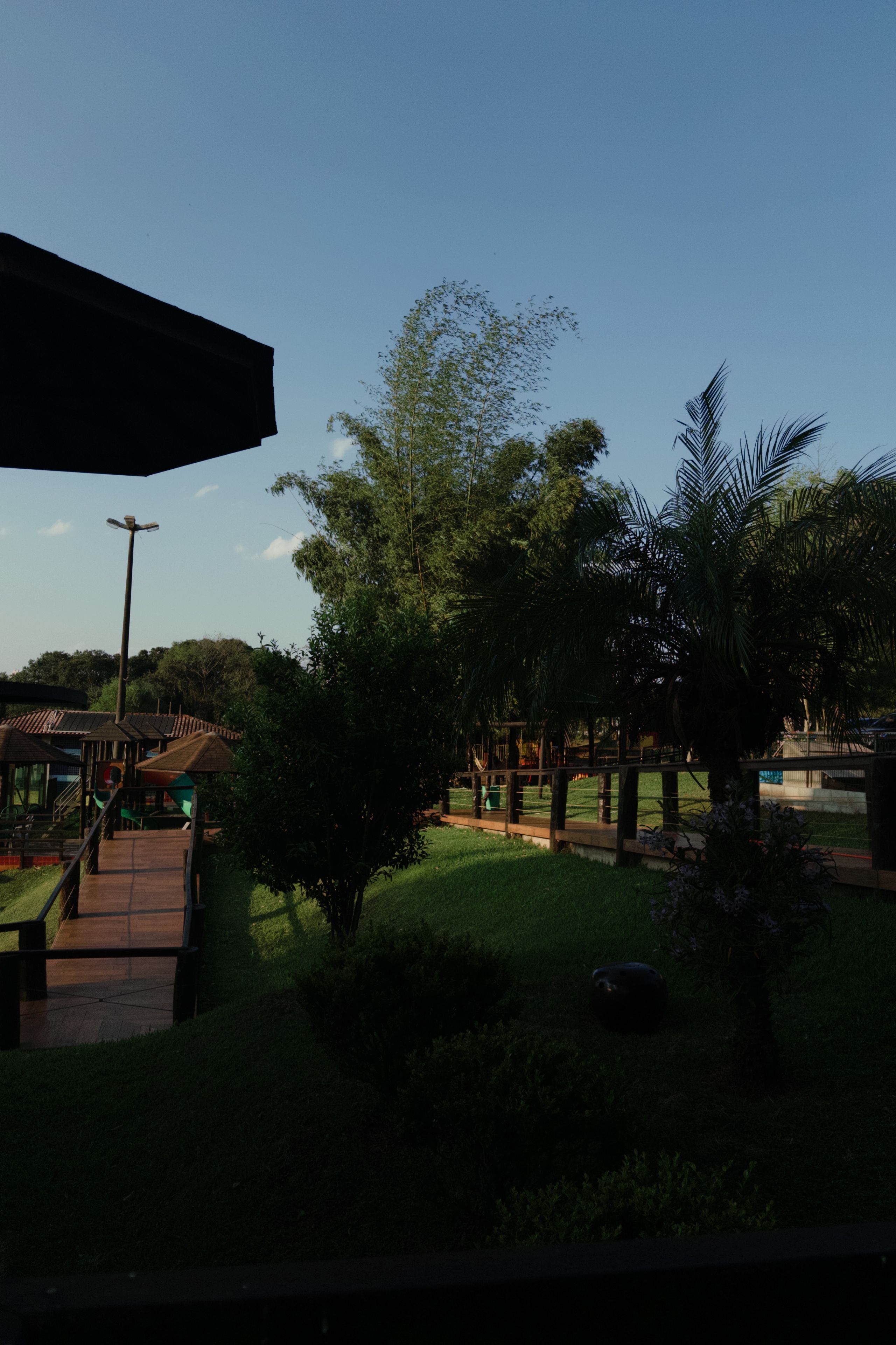 A park with pathways, a playground, and a covered area.