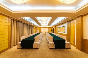 A conference room with a long table, chairs, and a projector screen. - Taixi Hotel (Feicheng)