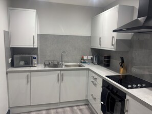 Cottage | Private kitchen | Dishwasher, cookware/dishes/utensils - The Newborough Apartment 1 (Scarborough)