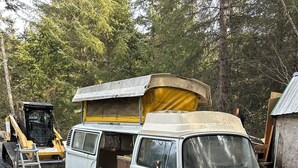 A white van with an open back and a yellow tarp covering the rear. - Enjoyable 1-bedroom RV in Seward (Seward)