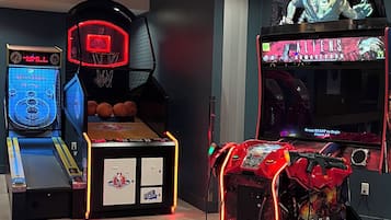 A gaming arcade with basketball and arcade games, including a basketball hoop and a basketball court.