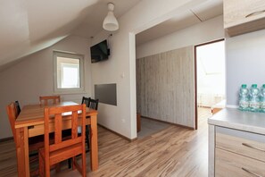 Enjoy meals at the dining table, relax in front of the flat-screen TV, and take in the view from the large window.