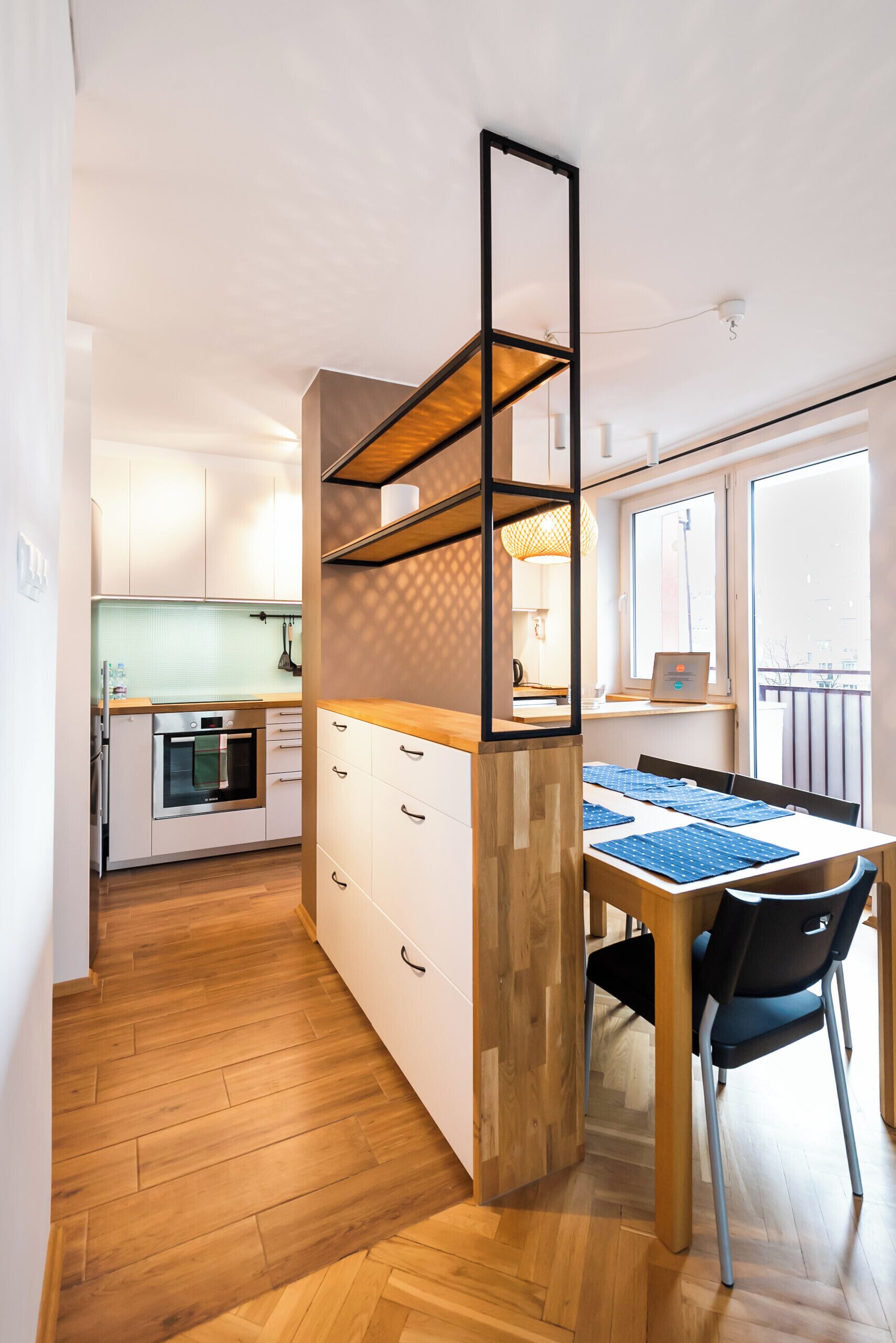A compact kitchen with white cabinets, a wooden countertop, and a built-in oven.