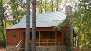 A rustic cabin with a metal roof, wooden exterior, stone foundation, and a wooden porch with steps leading to a door. - Paradise on the Little Red River and prime trout fishing! (Heber Springs)