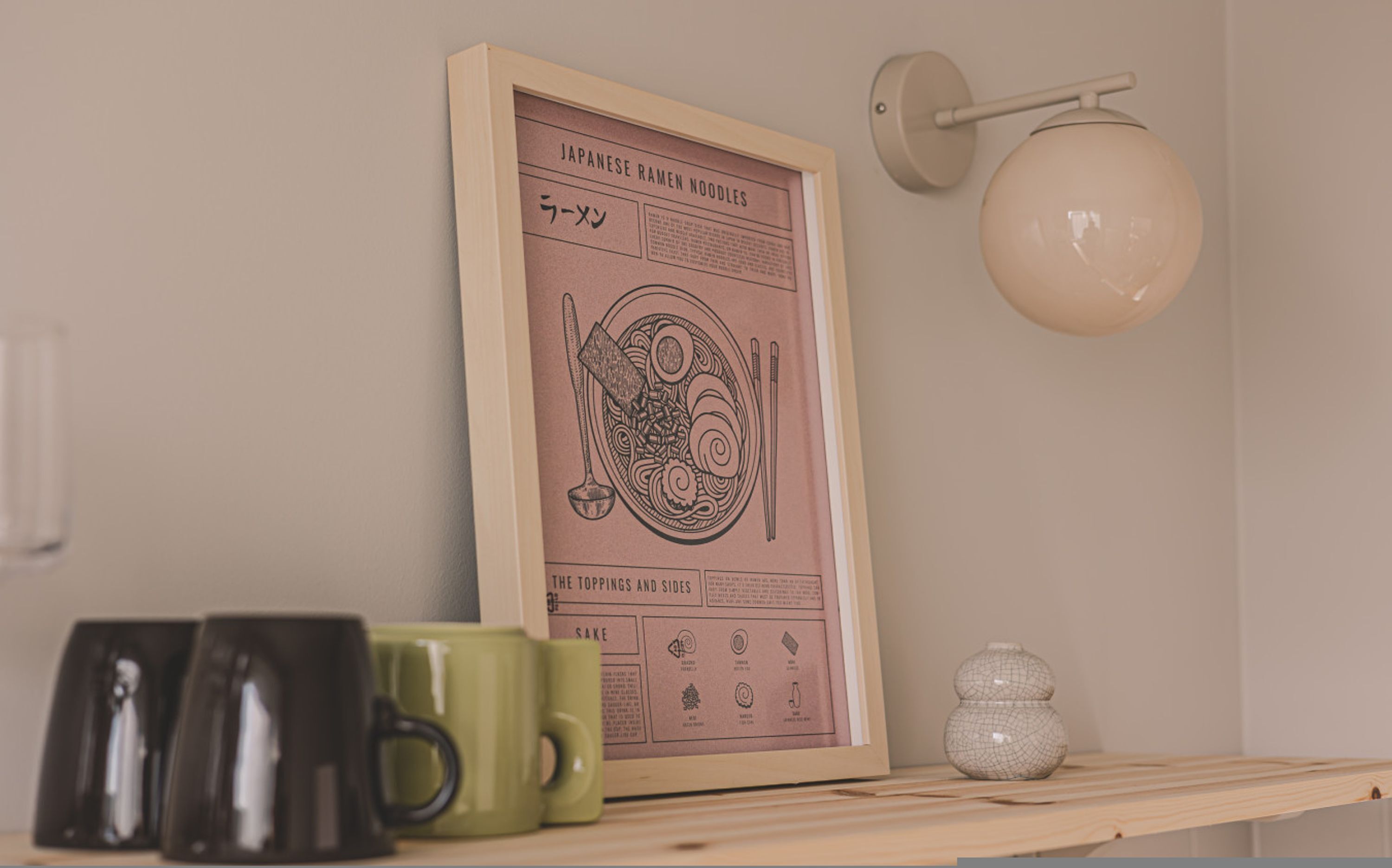 A framed menu of Japanese ramen noodles on a wall, a wall-mounted lamp, and a shelf with mugs and a ceramic vase.