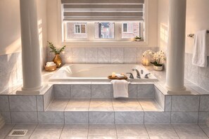 A modern bathroom with a large bathtub, a window with a view, and a potted plant. - 4BR Group Retreat by Canterra Stays · Sleeps 12 (Brampton)