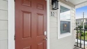 A red door with a window and a mailbox on the right side. - Luxury Studio • Steps to Beach • Kitchenette • Outdoor Seating (Fernandina Beach)