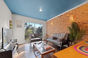 Apartamento ejecutivo, balcón, vistas a la ciudad | Sala de estar