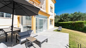 A modern outdoor patio with a dining set, a lounge chair, and a large umbrella. - Peaceful Lux, 3 Bed townhouse 10 min to the Beach REF016 (Mijas Costa)