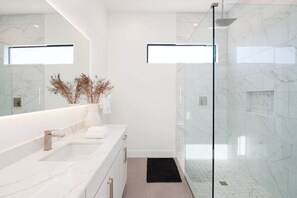 Shower, hair dryer, towels, shampoo