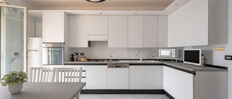 Fridge, dishwasher, coffee/tea maker, cookware/dishes/utensils