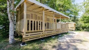 A wooden cabin with a sloped roof and a covered porch.