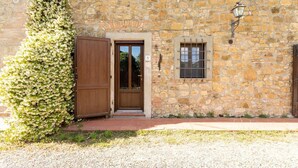 A stone building with a wooden door, a small window with bars, and a number '5' sign. - Villa 'Bianca Luce' with Private Pool, Private Terrace and Wi-Fi (Santa Luce)