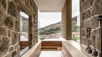 Relax in a spacious tub with a view of the surrounding landscape.