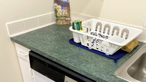 A kitchen with a dishwasher, a sink, and a calendar on the wall. - Charming 1-bedroom apartment close to downtown Seattle! (Seattle)