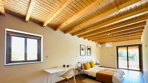 A bedroom with a wooden ceiling, a desk, a bed with a yellow pillow, and a large window. - Casa do Sol e Vinho: Breathtaking views & oasis of peace villa (Ourilhe)