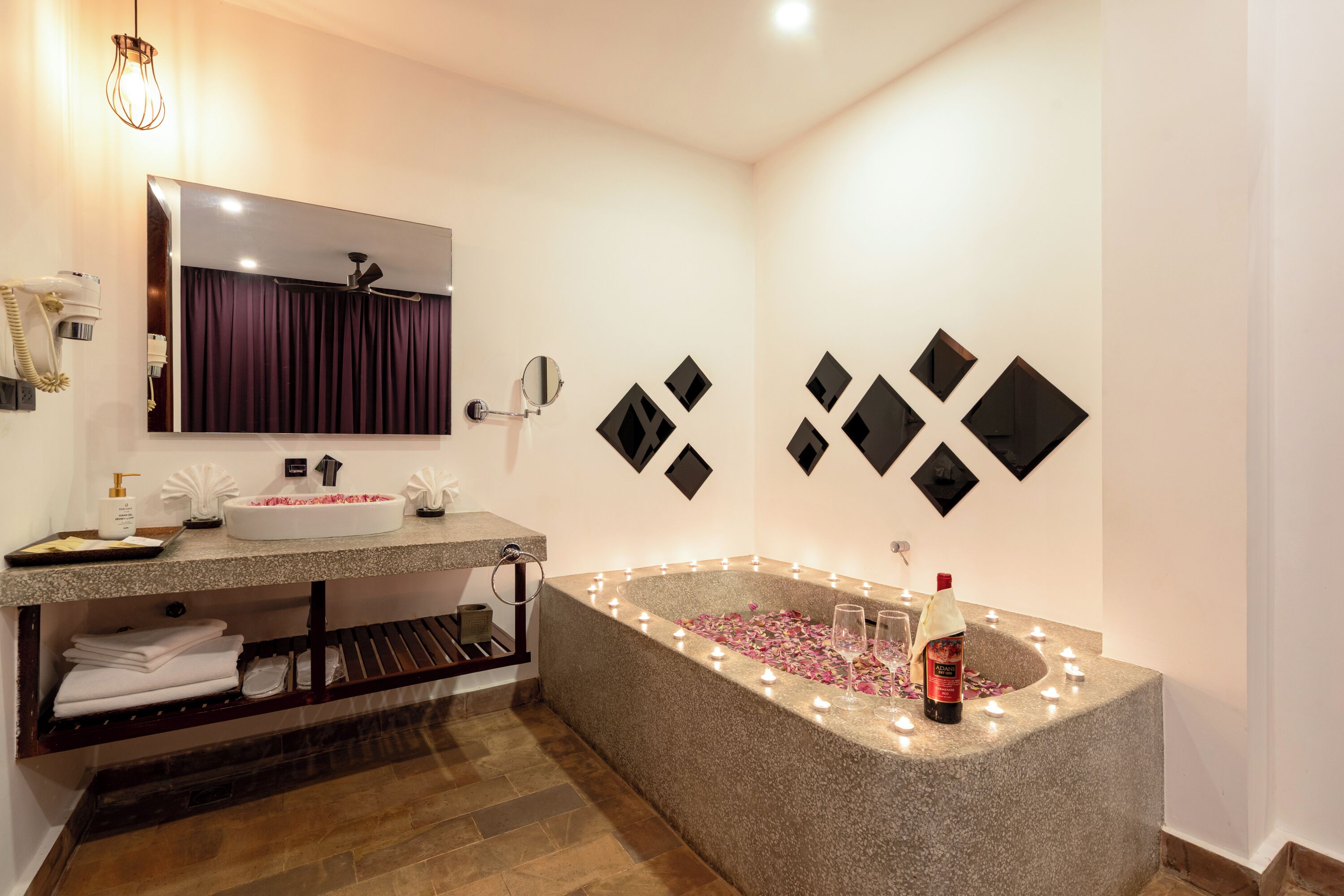 A modern bathroom with a freestanding bathtub, a vanity with a mirror, and a towel rack.