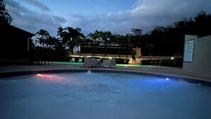A swimming pool with a view of a building in the background.