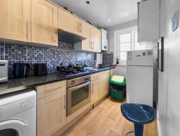 Enjoy cooking in this well-equipped kitchen with a dishwasher, oven, and refrigerator.