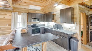 A modern kitchen with wooden beams, a built-in oven, a microwave, and a sink. - 5 Mi to Lake Barkley: Secluded Retreat in Kuttawa (Kuttawa)